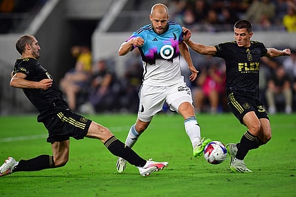 Oct 4, 2023; Los Angeles, California, USA; Los Angeles FC defender Sergi Palencia (30) and defender Giorgio Chiellini (14) play for the ball against Minnesota United forward Teemu Pukki (22) during the first half at BMO Stadium. Mandatory Credit: Gary A. Vasquez-USA TODAY Sports