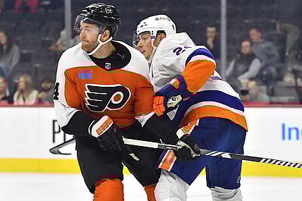 Oct 5, 2023; Philadelphia, Pennsylvania, USA; Philadelphia Flyers center Sean Couturier (14) and New York Islanders defenseman Scott Mayfield (24) battle for position during the third period at Wells Fargo Center. Mandatory Credit: Eric Hartline-USA TODAY Sports