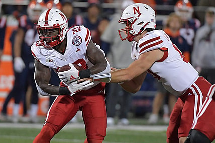 Oct 6, 2023; Champaign, Illinois, USA; Nebraska Cornhuskers quarterback Heinrich Haarberg (10) hands the ball to running back Anthony Grant (23) during the first half against the Illinois Fighting Illini at Memorial Stadium. Mandatory Credit: Ron Johnson-USA TODAY Sports