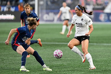 Oct 6, 2023; Seattle, Washington, USA; Washington Spirit forward Ashley Hatch (33) and OL Reign defender Emily Sonnett (2) battle for the ball during the second half at Lumen Field. Mandatory Credit: Steven Bisig-USA TODAY Sports