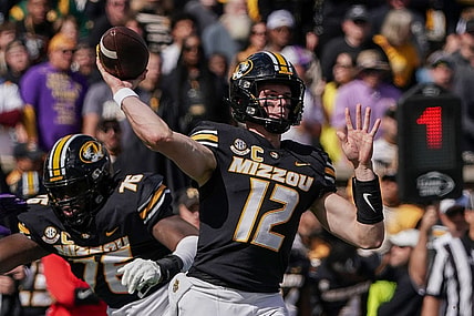 Oct 7, 2023; Columbia, Missouri, USA; Missouri Tigers quarterback Brady Cook (12) throws a pass against the LSU Tigers during the first half at Faurot Field at Memorial Stadium. Mandatory Credit: Denny Medley-USA TODAY Sports