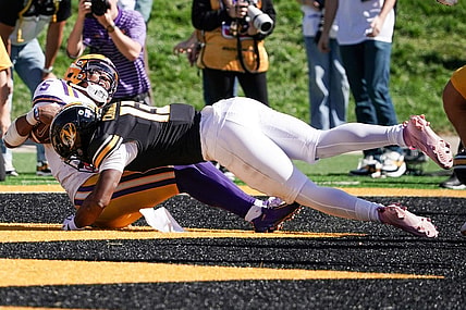 Oct 7, 2023; Columbia, Missouri, USA; LSU Tigers quarterback Jayden Daniels (5) scores a touchdown as Missouri Tigers defensive back Daylan Carnell (13) makes the tackle during the second half at Faurot Field at Memorial Stadium. Mandatory Credit: Denny Medley-USA TODAY Sports