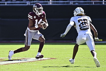 Oct 7, 2023; Starkville, Mississippi, USA; Mississippi State Bulldogs quarterback Mike Wright (14) runs the ball while defended by Western Michigan Broncos cornerback Aaron Wofford (25) during the fourth quarter at Davis Wade Stadium at Scott Field. Mandatory Credit: Matt Bush-USA TODAY Sports