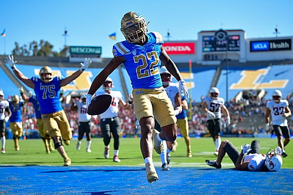Oct 7, 2023; Pasadena, California, USA; UCLA Bruins wide receiver Keegan Jones (22) scores a touchdown against the Washington State Cougars during the second half at Rose Bowl. Mandatory Credit: Gary A. Vasquez-USA TODAY Sports
