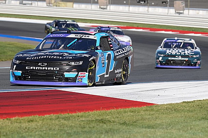 Oct 7, 2023; Concord, North Carolina, USA; NASCAR Xfinity Series driver Sam Mayer (1) leads driver Josh Berry (8) out of turn five during the Drive for the Cure 250 at Charlotte Motor Speedway Road Course. Mandatory Credit: Jim Dedmon-USA TODAY Sports