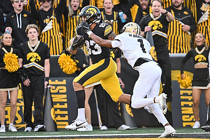 Oct 7, 2023; Iowa City, Iowa, USA; Iowa Hawkeyes tight end Erick All (83) catches a touchdown pass from quarterback Deacon Hill (not pictured) as Purdue Boilermakers Markevious Brown (1) defends during the fourth quarter at Kinnick Stadium. Mandatory Credit: Jeffrey Becker-USA TODAY Sports
