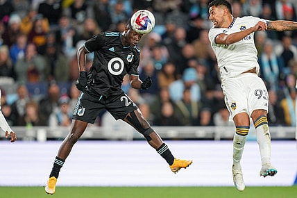 Oct 7, 2023; Saint Paul, Minnesota, USA; Minnesota United forward Bongokuhle Hlongwane (21) heads the ball against Los Angeles Galaxy defender Tony Alfaro (93) in the first half at Allianz Field. Mandatory Credit: Matt Blewett-USA TODAY Sports