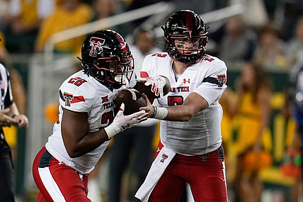 Oct 7, 2023; Waco, Texas, USA; Texas Tech Red Raiders quarterback Behren Morton (2) hands the ball off to Texas Tech Red Raiders running back Tahj Brooks (28) against the Baylor Bears during the second half at McLane Stadium. Mandatory Credit: Chris Jones-USA TODAY Sports
