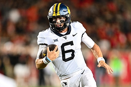 Oct 12, 2023; Houston, Texas, USA; West Virginia Mountaineers quarterback Garrett Greene (6) runs the ball in for a touchdown during the fourth quarter against the Houston Cougars  at TDECU Stadium. Mandatory Credit: Maria Lysaker-USA TODAY Sports