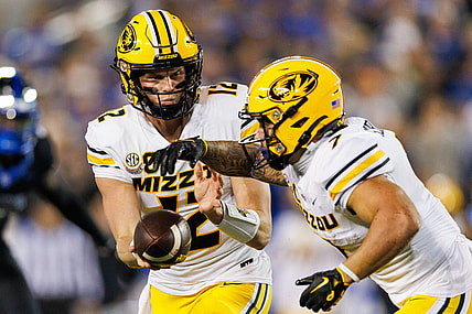 Oct 14, 2023; Lexington, Kentucky, USA; Missouri Tigers quarterback Brady Cook (12) hands the ball to running back Cody Schrader (7) during the first quarter against the Kentucky Wildcats at Kroger Field. Mandatory Credit: Jordan Prather-USA TODAY Sports