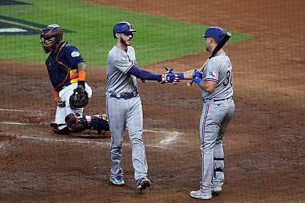 Oct 16, 2023; Houston, Texas, USA; Texas Rangers catcher Jonah Heim (28) celebrates with first baseman Nathaniel Lowe (30) after hitting a home run in the third inning against the Houston Astros during game two of the ALCS for the 2023 MLB playoffs at Minute Maid Park. Mandatory Credit: Troy Taormina-USA TODAY Sports