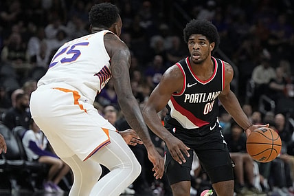 Oct 16, 2023; Phoenix, Arizona, USA; Portland Trail Blazers guard Scoot Henderson (00) drives past Phoenix Suns guard Nassir Little (25) in the second half at Footprint Center. Mandatory Credit: Rick Scuteri-USA TODAY Sports