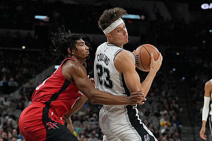 Oct 18, 2023; San Antonio, Texas, USA; San Antonio Spurs forward Zach Collins (23) spins around Houston Rockets forward Jermaine Samuels (00) in the first half at the Frost Bank Center. Mandatory Credit: Daniel Dunn-USA TODAY Sports