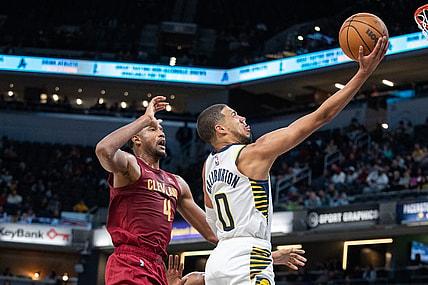 Oct 20, 2023; Indianapolis, Indiana, USA; Indiana Pacers guard Tyrese Haliburton (0) shoots the ball while Cleveland Cavaliers forward Evan Mobley (4) defends in the second half at Gainbridge Fieldhouse. Mandatory Credit: Trevor Ruszkowski-USA TODAY Sports