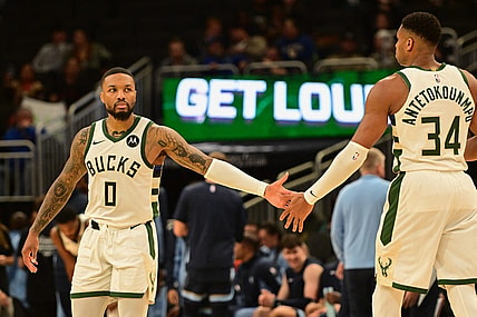 Oct 20, 2023; Milwaukee, Wisconsin, USA; Milwaukee Bucks guard Damian Lillard (0) greets forward Giannis Antetokounmpo (34) during game against the Memphis Grizzlies at Fiserv Forum. Mandatory Credit: Benny Sieu-USA TODAY Sports