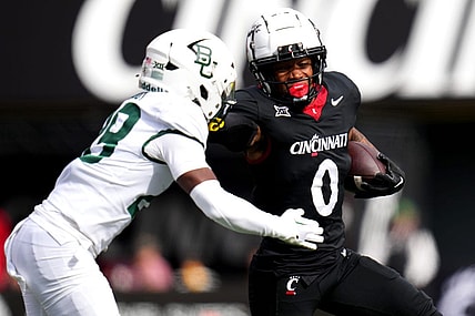 Cincinnati Bearcats wide receiver Braden Smith (0) stiff arms Baylor Bears safety Romario Noel (29) on a carry in the first quarter during a college football game between the Baylor Bears and the Cincinnati Bearcats, Saturday, Oct. 21, 2023, at Nippert Stadium in Cincinnati.