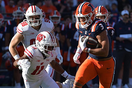Oct 21, 2023; Champaign, Illinois, USA;  Illinois Fighting Illini running back Kaden Feagin (3) runs the ball against Wisconsin Badgers cornerback Alexander Smith (11) during the first half at Memorial Stadium. Mandatory Credit: Ron Johnson-USA TODAY Sports