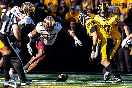 Minnesota defensive back Tyler Nubin (27) jumps on a fumble by Iowa quarterback Deacon Hill (10) at Kinnick Stadium on Saturday, October 21, 2023 in Iowa City.