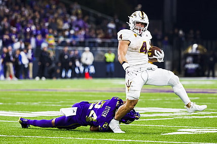 Oct 21, 2023; Seattle, Washington, USA; Arizona State Sun Devils running back Cameron Skattebo (4) breaks a table attempt by Washington Huskies safety Makell Esteen (24) while rushing during the fourth quarter at Alaska Airlines Field at Husky Stadium. Mandatory Credit: Joe Nicholson-USA TODAY Sports