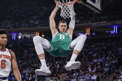 Oct 25, 2023; New York, New York, USA; Boston Celtics center Kristaps Porzingis (8) hangs on the rim after a dunk in the first quarter against the New York Knicks at Madison Square Garden. Mandatory Credit: Wendell Cruz-USA TODAY Sports