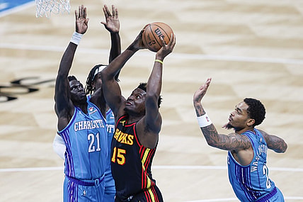 Oct 25, 2023; Charlotte, North Carolina, USA; Atlanta Hawks center Clint Capela (15) drives to the basket between Charlotte Hornets forwards JT Thor and  P.J. Washington (25) during the second quarter at Spectrum Center. Mandatory Credit: Nell Redmond-USA TODAY Sports
