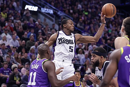 Oct 25, 2023; Salt Lake City, Utah, USA;  Sacramento Kings guard De'Aaron Fox (5) passes the ball away from Utah Jazz guard Kris Dunn (11) during the second quarter at Delta Center. Mandatory Credit: Chris Nicoll-USA TODAY Sports