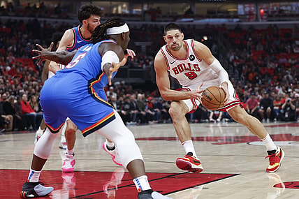 Oct 25, 2023; Chicago, Illinois, USA; Chicago Bulls center Nikola Vucevic (9) looks to pass the ball against Oklahoma City Thunder guard Luguentz Dort (5) during the first half of a basketball game at United Center. Mandatory Credit: Kamil Krzaczynski-USA TODAY Sports