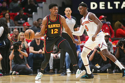 Oct 27, 2023; Atlanta, Georgia, USA; Atlanta Hawks forward De'Andre Hunter (12) is defended by New York Knicks guard RJ Barrett (9) in the first quarter at State Farm Arena. Mandatory Credit: Brett Davis-USA TODAY Sports
