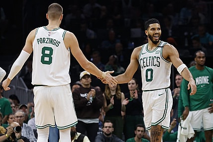 Oct 27, 2023; Boston, Massachusetts, USA; Boston Celtics forward Jayson Tatum (0) slaps hands with center Kristaps Porzingis (8) during the second quarter against the Miami Heat at TD Garden. Mandatory Credit: Winslow Townson-USA TODAY Sports