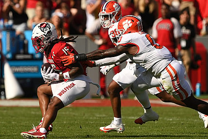 Oct 28, 2023; Raleigh, North Carolina, USA; North Carolina State Wolfpack receiver Keyon Lesane (15) runs after a catch against Clemson Tigers linebacker Barrett Carter (0) and safety Khalil Barnes (36) during the second quarter at Carter-Finley Stadium. Mandatory Credit: Ken Ruinard-USA TODAY Sports