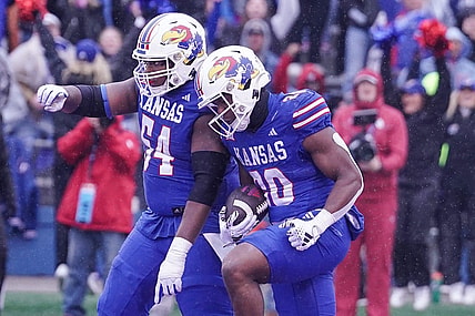Oct 28, 2023; Lawrence, Kansas, USA; Kansas Jayhawks running back Daniel Hishaw Jr. (20) celebrates with offensive lineman Michael Ford Jr. (54) after scoring against the Oklahoma Sooners during the first half at David Booth Kansas Memorial Stadium. Mandatory Credit: Denny Medley-USA TODAY Sports