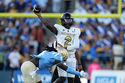 Oct 28, 2023; Pasadena, California, USA; UCLA Bruins quarterback Ethan Garbers (4) throws the ball against UCLA Bruins defensive lineman Carl Jones Jr. (4) in the first half at Rose Bowl. Mandatory Credit: Kirby Lee-USA TODAY Sports