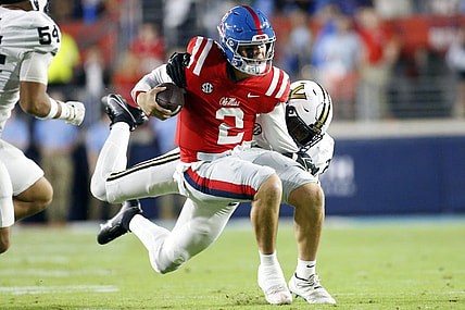 Oct 28, 2023; Oxford, Mississippi, USA; Mississippi Rebels quarterback Jaxson Dart (2) runs with the ball as he is tackled by Vanderbilt Commodores defensive end-linebacker Miles Capers (29) during the first half at Vaught-Hemingway Stadium. Mandatory Credit: Petre Thomas-USA TODAY Sports