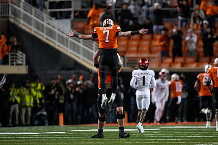 Oklahoma State Cowboys quarterback Alan Bowman (7) and offensive lineman Dalton Cooper (71) celebrate a touchdown pass in the first quarter of the NCAA Big12 football game between the Oklahoma State Cowboys and the Cincinnati Bearcats at Boone Pickens Stadium in Stillwater, Okla., on Saturday, Oct. 28, 2023.