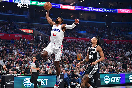 Oct 29, 2023; Los Angeles, California, USA; Los Angeles Clippers forward Paul George (13) scores a basket ahead of San Antonio Spurs guard Devin Vassell (24) during the first half at Crypto.com Arena. Mandatory Credit: Gary A. Vasquez-USA TODAY Sports