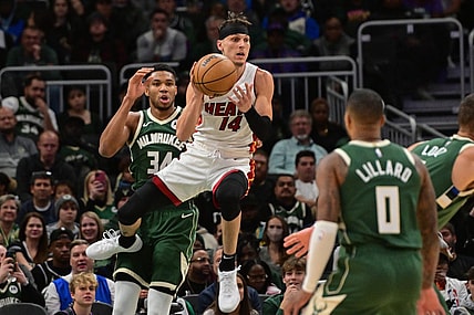 Oct 30, 2023; Milwaukee, Wisconsin, USA;  Miami Heat guard Tyler Herro (14) grabs a rebound against Milwaukee Bucks forward Giannis Antetokounmpo (34) in the first quarter at Fiserv Forum. Mandatory Credit: Benny Sieu-USA TODAY Sports