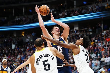 Oct 30, 2023; Denver, Colorado, USA; Utah Jazz guard Collin Sexton (2) fouls Denver Nuggets center Nikola Jokic (15) in the second half at Ball Arena. Mandatory Credit: Ron Chenoy-USA TODAY Sports