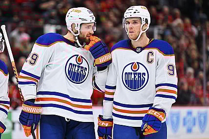 Nov 30, 2022; Chicago, Illinois, USA;  Edmonton Oilers forward Leon Draisaitl (29) and forward Connor McDavid (97) talk before a face off against the Chicago Blackhawks at United Center. Mandatory Credit: Jamie Sabau-USA TODAY Sports