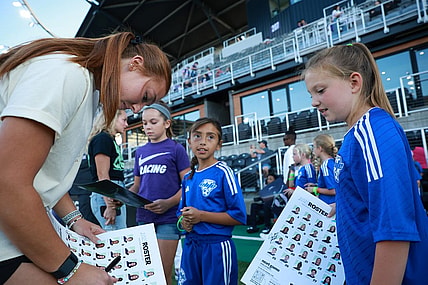 Sep 15, 2023; Louisville, Kentucky, USA; Racing Louisville FC goalkeeper Jordyn Bloomer (24) signs autographs before the match against the Houston Dash at Lynn Family Stadium. Mandatory Credit: EM Dash-USA TODAY Sports