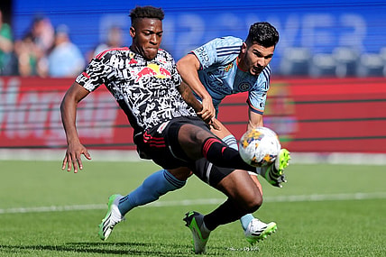 Sep 16, 2023; New York, New York, USA; New York Red Bulls defender Hassan Ndam (98) plays the ball against New York City FC forward Mounsef Bakrar (9) during the first half at Yankee Stadium. Mandatory Credit: Brad Penner-USA TODAY Sports