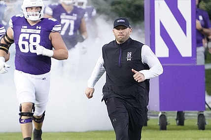 Sep 23, 2023; Evanston, Illinois, USA; Northwestern Wildcats head coach David Braun leads his team on the field before the game against the Minnesota Golden Gophers at Ryan Field. Mandatory Credit: David Banks-USA TODAY Sports