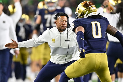 Oct 14, 2023; South Bend, Indiana, USA; Notre Dame Fighting Irish head coach Marcus Freeman celebrates with safety Xavier Watts (0) after Watts intercepted a pass in the first quarter against the USC Trojans at Notre Dame Stadium. Notre Dame won 48-20. Mandatory Credit: Matt Cashore-USA TODAY Sports