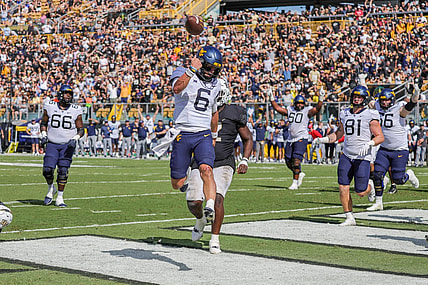 Oct 28, 2023; Orlando, Florida, USA; West Virginia Mountaineers quarterback Garrett Greene (6) scores a touchdown against the UCF Knights during the second half at FBC Mortgage Stadium. Mandatory Credit: Mike Watters-USA TODAY Sports