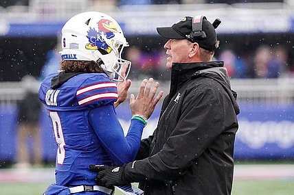 Oct 28, 2023; Lawrence, Kansas, USA; Kansas Jayhawks quarterback Jason Bean (9) talks with Kansas Jayhawks Kansas Jayhawks on field against the Oklahoma Sooners during the second half at David Booth Kansas Memorial Stadium. Mandatory Credit: Denny Medley-USA TODAY Sports