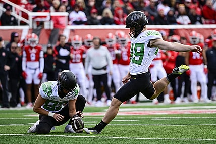 Oct 28, 2023; Salt Lake City, Utah, USA; Oregon Ducks kicker Camden Lewis (49) kicks a PAT against the Utah Utes during the first half at Rice-Eccles Stadium. Mandatory Credit: Christopher Creveling-USA TODAY Sports