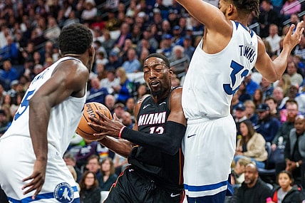 Oct 28, 2023; Minneapolis, Minnesota, USA; Miami Heat center Bam Adebayo (13) drives to the basket as Minnesota Timberwolves center Karl-Anthony Towns (32) and guard Anthony Edwards (5) defend in the second quarter at Target Center. Mandatory Credit: Matt Blewett-USA TODAY Sports