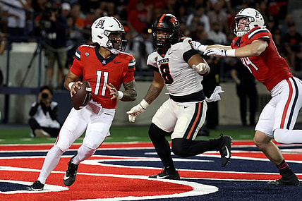 Oct 28, 2023; Tucson, Arizona, USA; Arizona Wildcats quarterback Noah Fifita #11 drops back to make a pass against Oregon State Beavers defensive lineman Sione Lolohea #8 during the first half at Arizona Stadium. Mandatory Credit: Zachary BonDurant-USA TODAY Sports