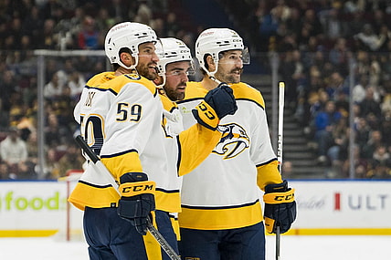 Oct 31, 2023; Vancouver, British Columbia, CAN; Nashville Predators defenseman Roman Josi (59) and defenseman Dante Fabbro (57) and forward Filip Forsberg (9) celebrate Fabbro   s goal against the Vancouver Canucks in the first period at Rogers Arena. Mandatory Credit: Bob Frid-USA TODAY Sports