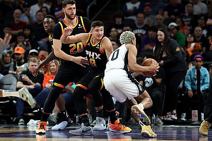 Oct 31, 2023; Phoenix, Arizona, USA; San Antonio Spurs forward Jeremy Sochan #10 drives to the net agaisnt Phoenix Suns guard Grayson Allen #8 and center Jusuf Nurkic #20 during the second half at Footprint Center. Mandatory Credit: Zachary BonDurant-USA TODAY Sports