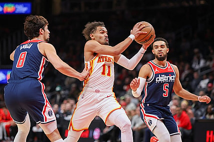 Nov 1, 2023; Atlanta, Georgia, USA; Atlanta Hawks guard Trae Young (11) drives past Washington Wizards forward Deni Avdija (8) and guard Tyus Jones (5) in the first quarter at State Farm Arena. Mandatory Credit: Brett Davis-USA TODAY Sports